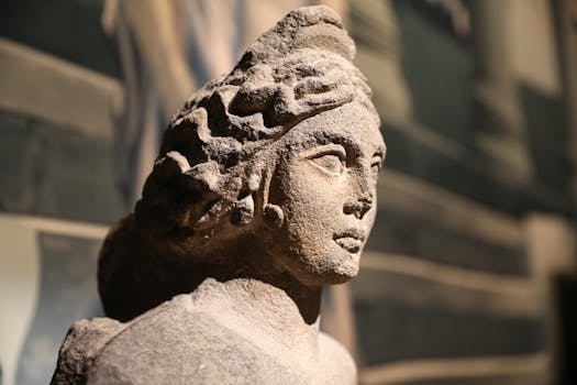 Close-up view of a detailed ancient stone sculpture in a museum setting.